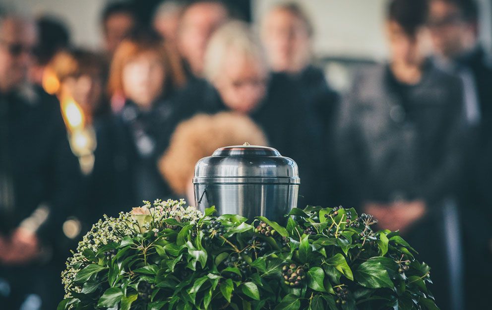 Urne im Saal mit Menschen im Hintergrund